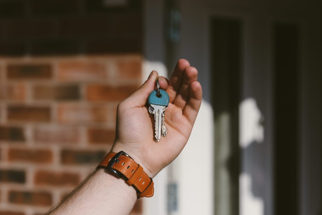 person holding new house keys